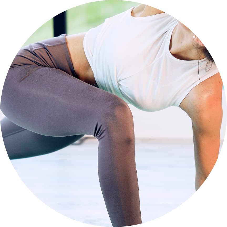 Menopause and perimenopause woman wearing gray leggings and a white top outdoors